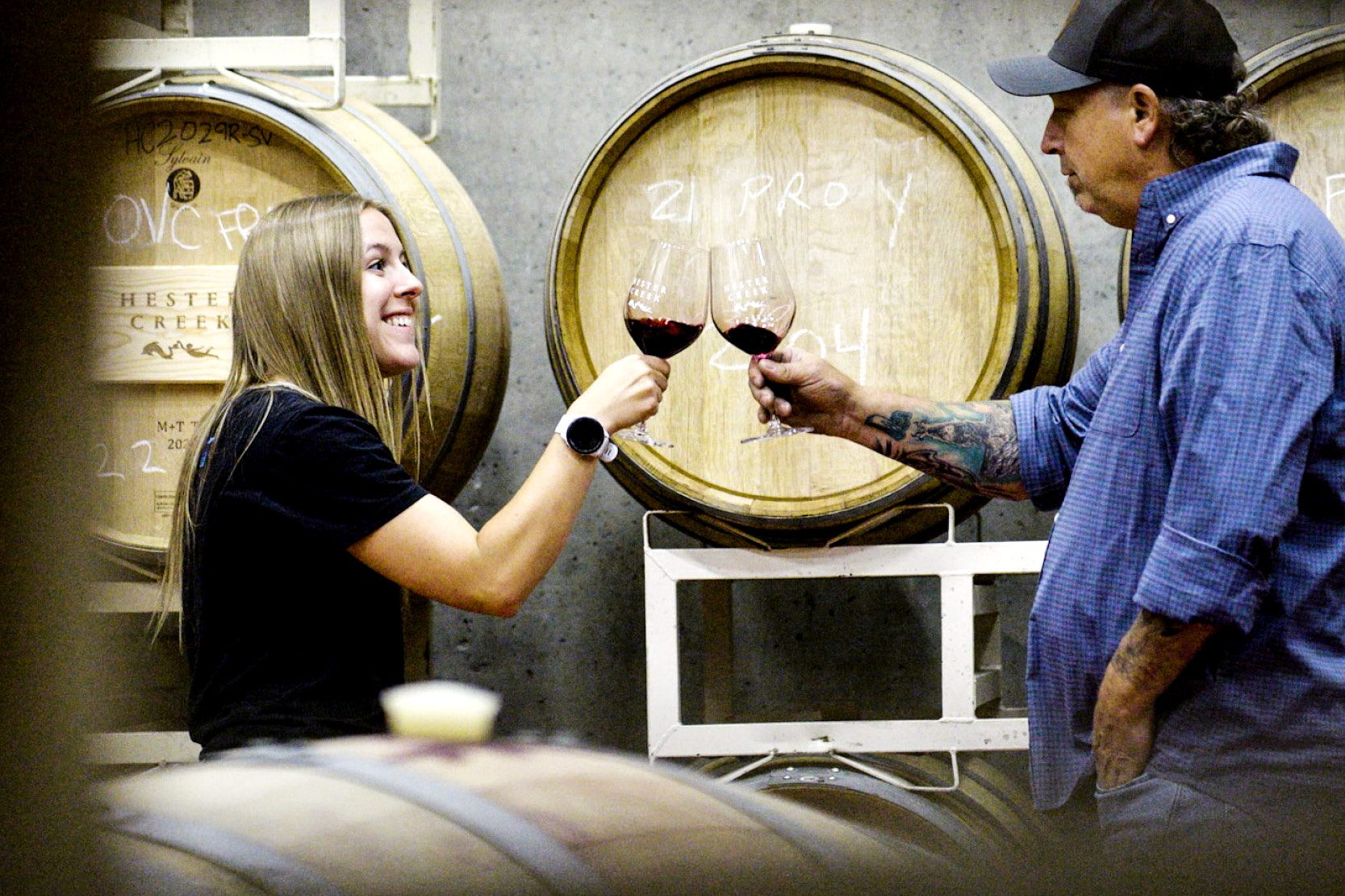 Winemakers cheering with a glass of red wine
