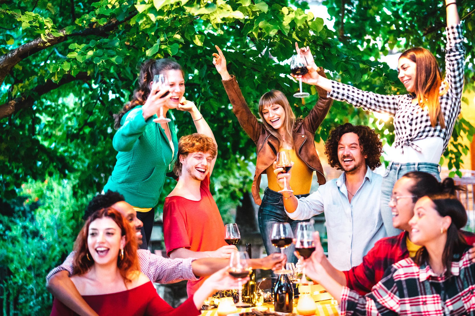 group of people sitting around enjoying wine